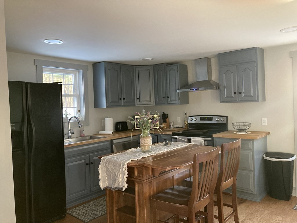 3 Pine Street Gardner, MA 01440 - Photo 10 of 32 a kitchen with a stove a refrigerator and a stove top oven