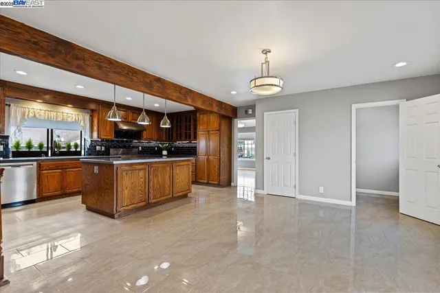 a kitchen with stainless steel appliances granite countertop a stove a sink and a refrigerator