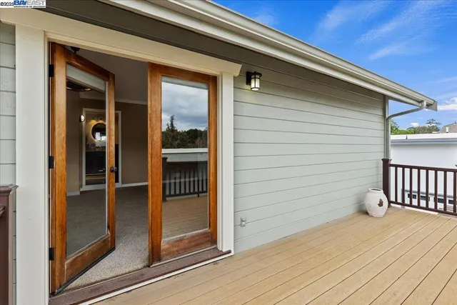 a bathroom with a granite countertop double vanity and a mirror