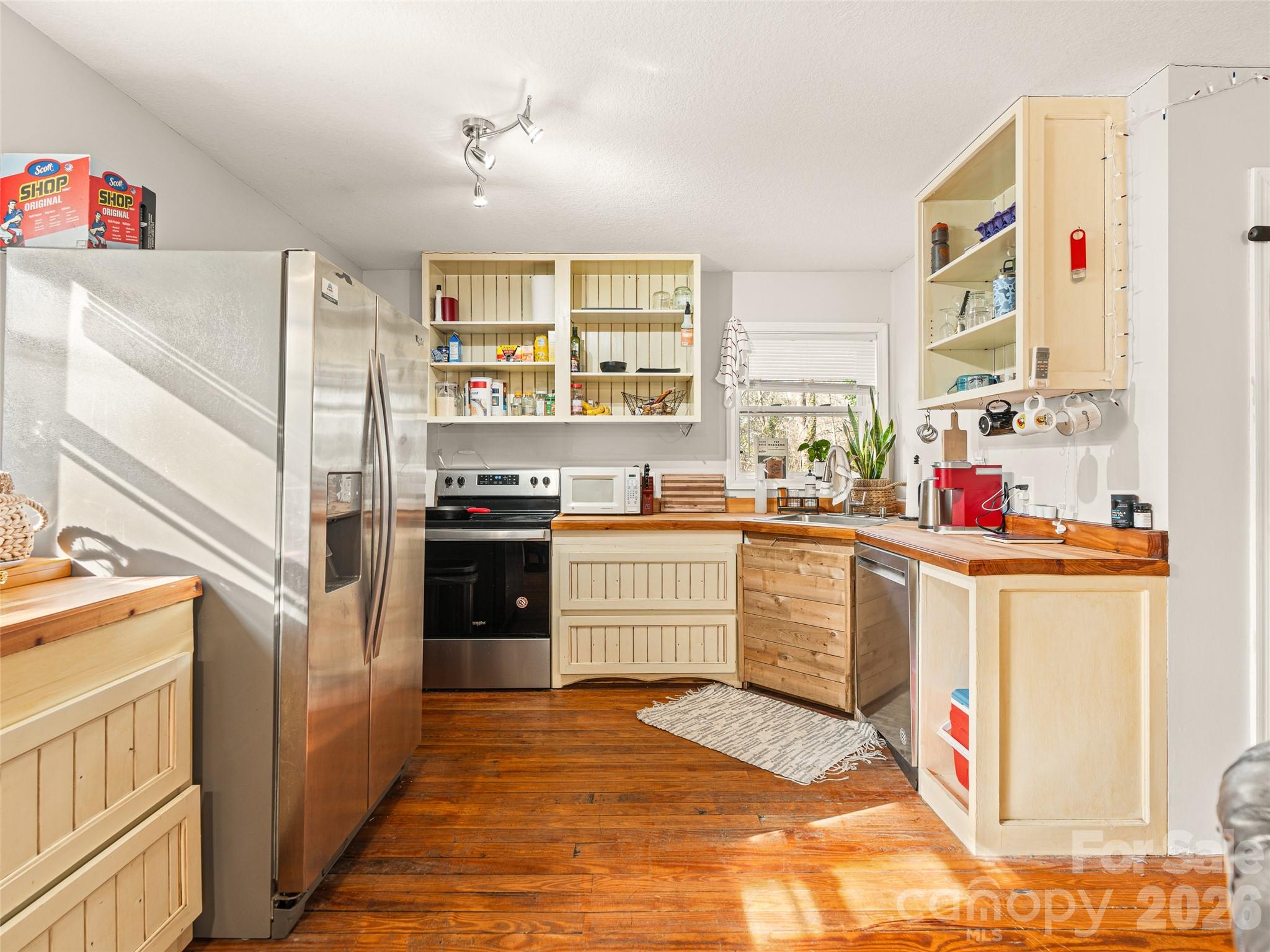 6 Nelson Road Hendersonville, NC 28791 - Photo 16 of 18 a kitchen with stainless steel appliances granite countertop a stove and a refrigerator