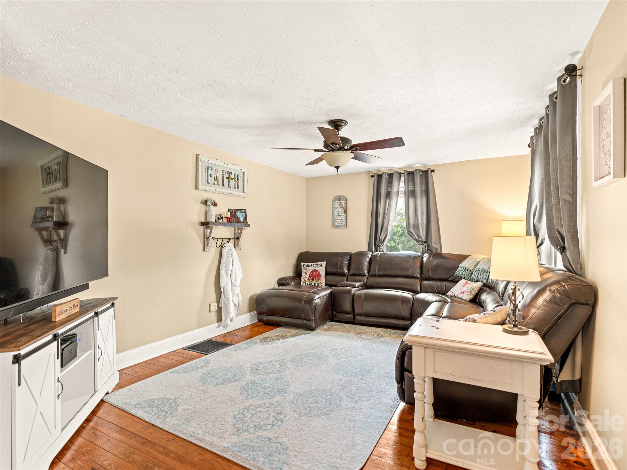 6 Nelson Road Hendersonville, NC 28791 - Photo 4 of 18 a living room with furniture and a flat screen tv