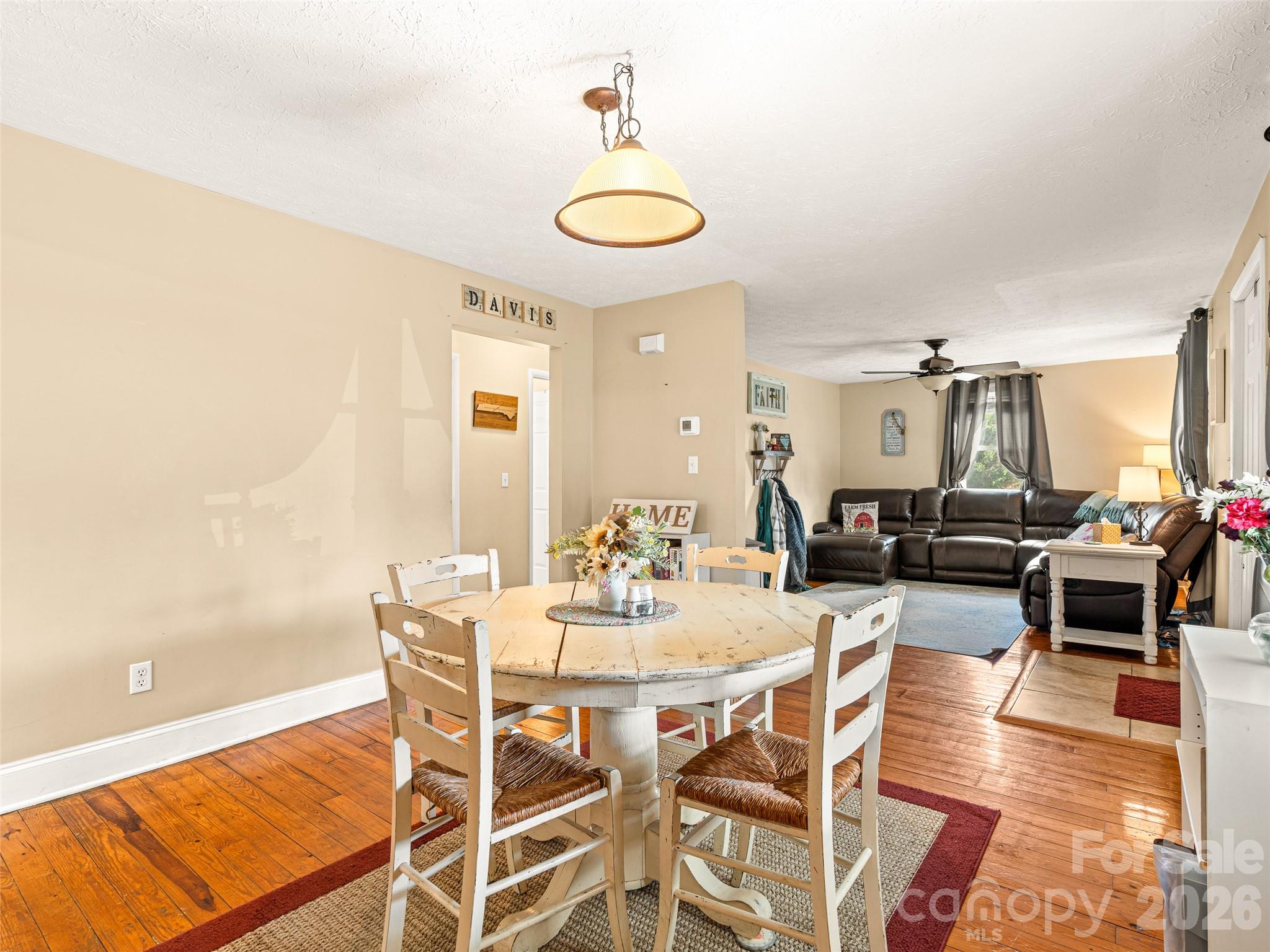 6 Nelson Road Hendersonville, NC 28791 - Photo 7 of 18 a dining room with furniture a rug and wooden floor