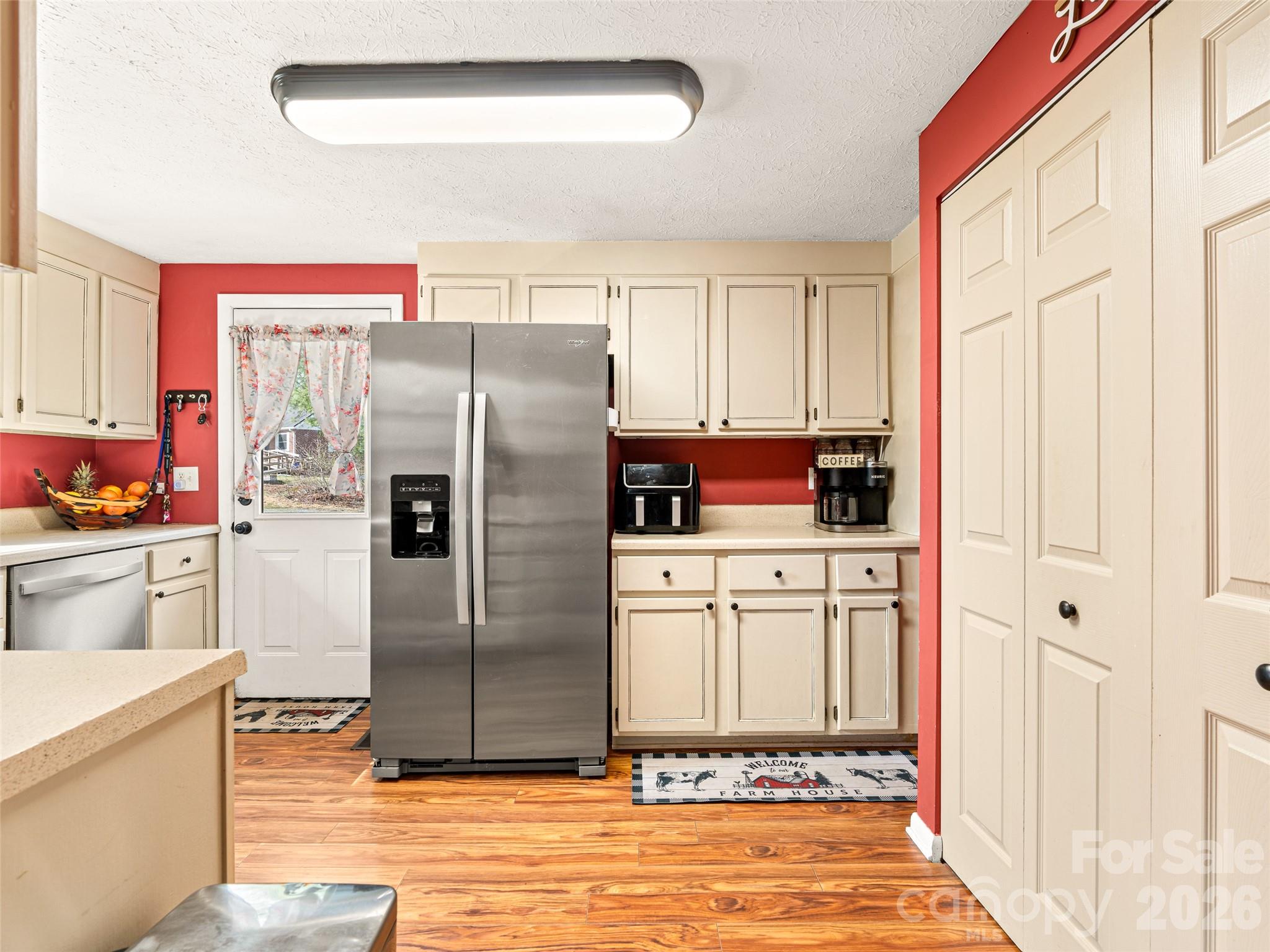 6 Nelson Road Hendersonville, NC 28791 - Photo 8 of 18 a kitchen with stainless steel appliances a refrigerator sink and cabinets
