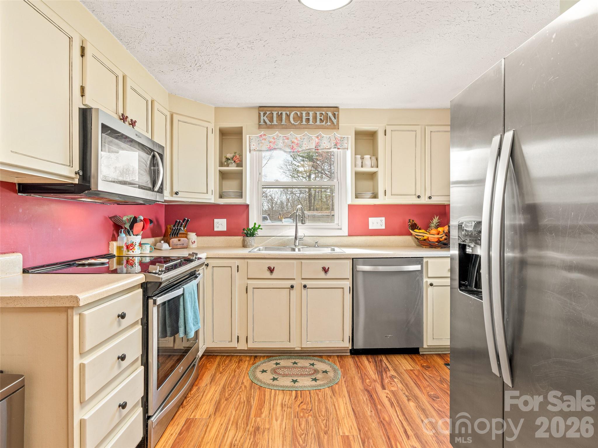 6 Nelson Road Hendersonville, NC 28791 - Photo 9 of 18 a kitchen with granite countertop a sink stainless steel appliances and cabinets
