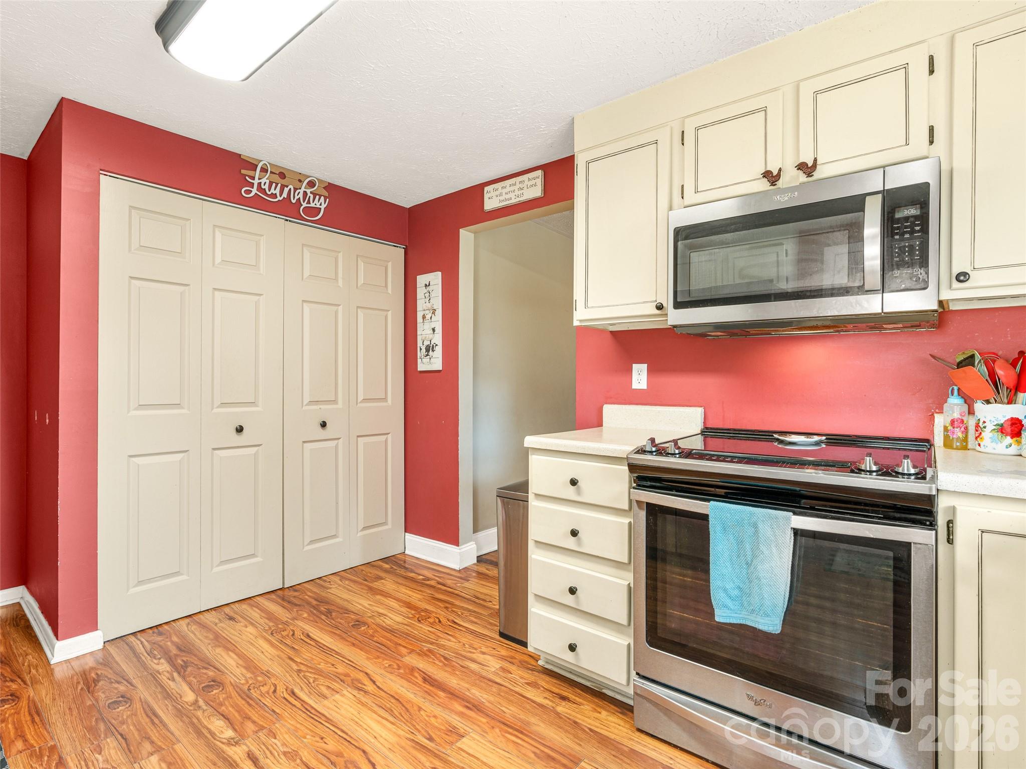6 Nelson Road Hendersonville, NC 28791 - Photo 10 of 18 a kitchen with stainless steel appliances granite countertop a stove and a microwave