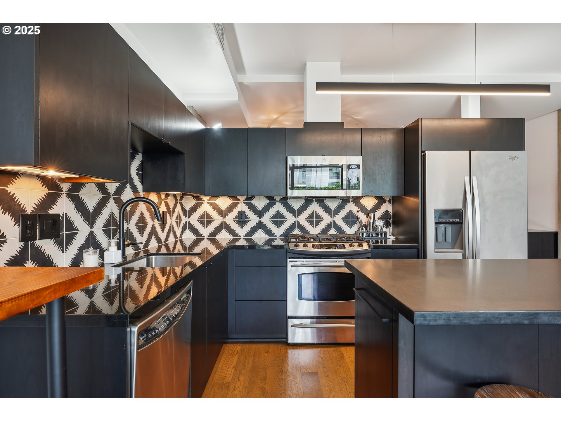 1221 Southwest 10th Avenue, Unit 410 Portland, OR 97205 - Photo 14 of 26 a kitchen with stainless steel appliances granite countertop a sink and cabinets