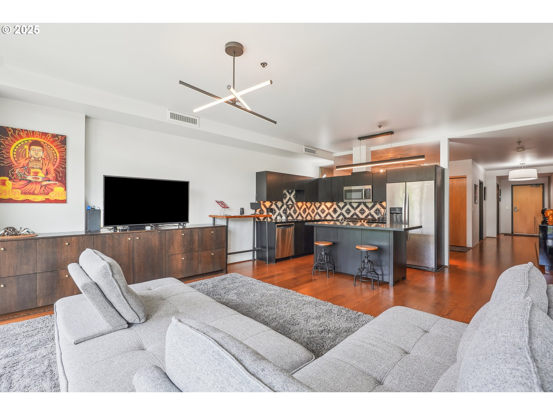 1221 Southwest 10th Avenue, Unit 410 Portland, OR 97205 - Photo 15 of 26 a living room with furniture and a flat screen tv