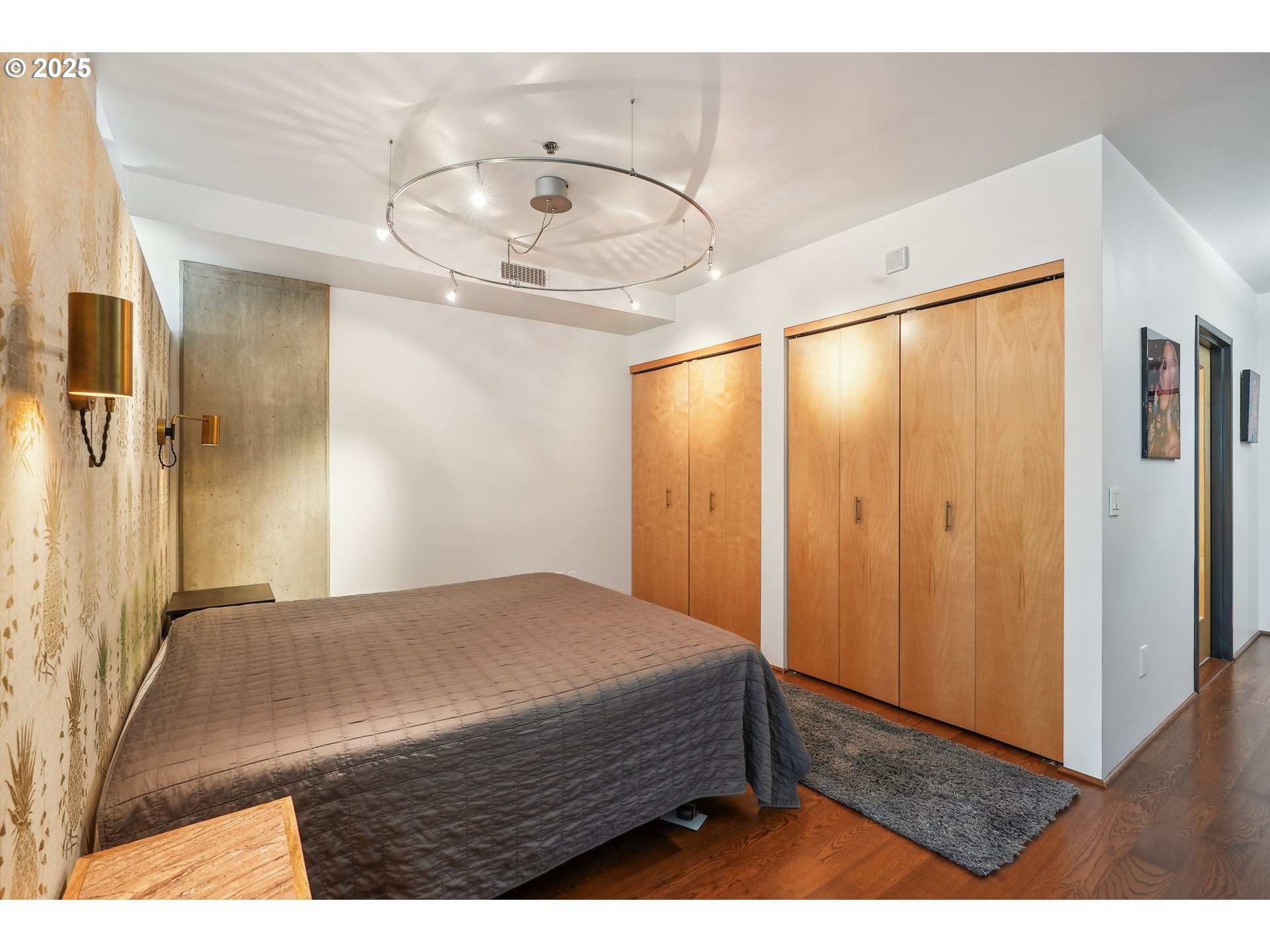 1221 Southwest 10th Avenue, Unit 410 Portland, OR 97205 - Photo 16 of 26 a bedroom with a bed and a large mirror