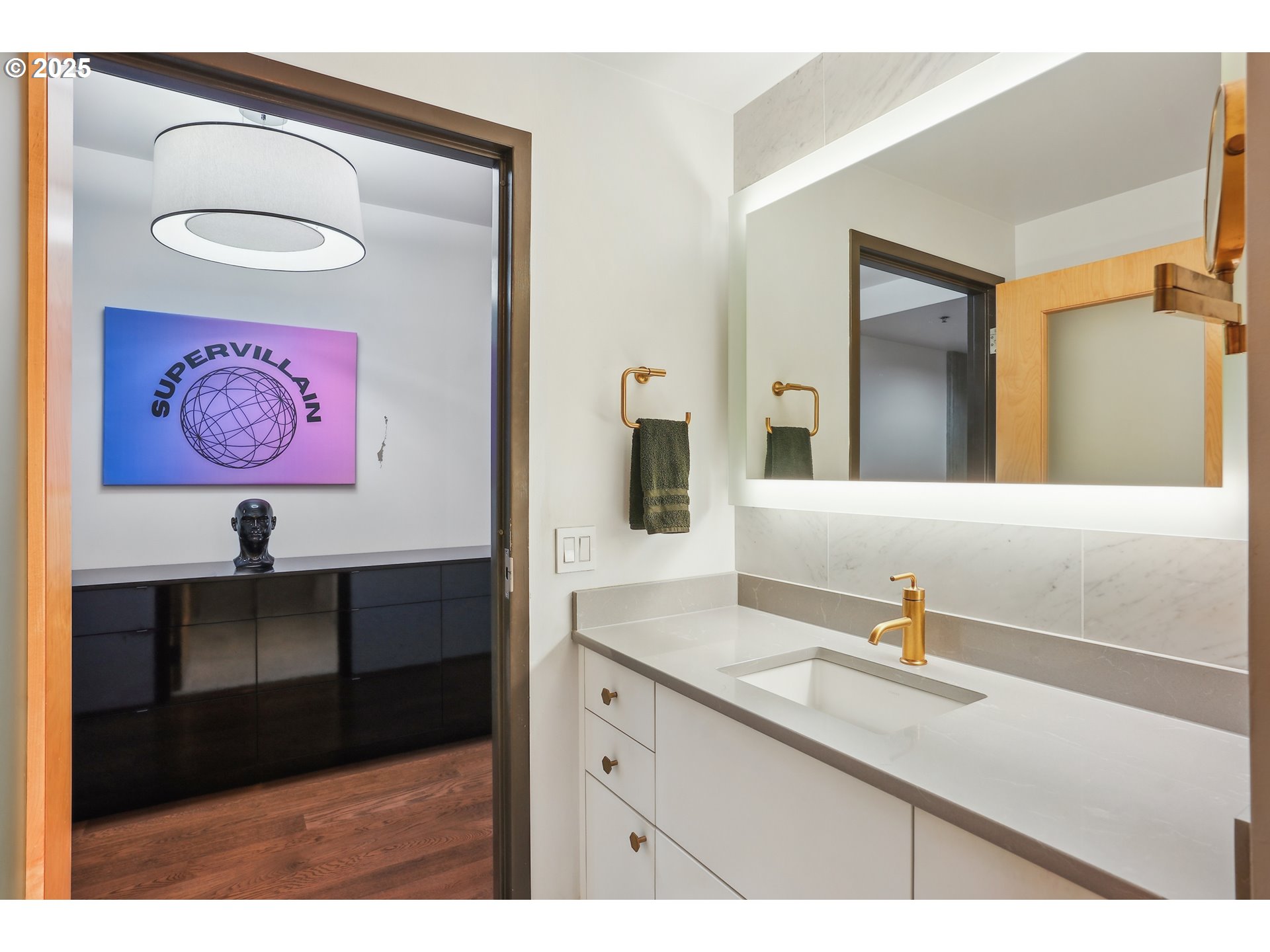 1221 Southwest 10th Avenue, Unit 410 Portland, OR 97205 - Photo 21 of 26 a bathroom with a sink a mirror and a painting on the wall