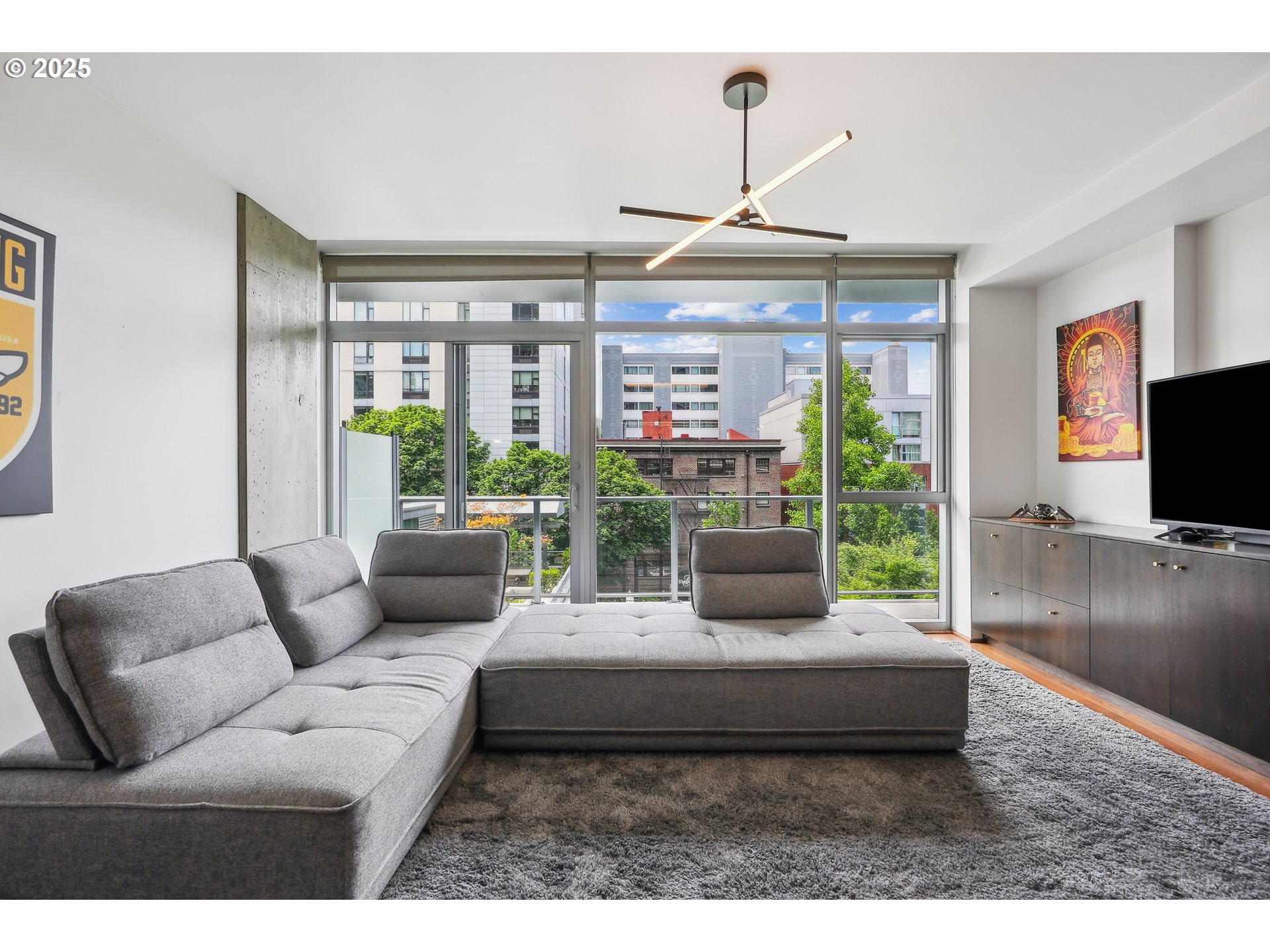 1221 Southwest 10th Avenue, Unit 410 Portland, OR 97205 - Photo 5 of 26 a living room with furniture and a flat screen tv