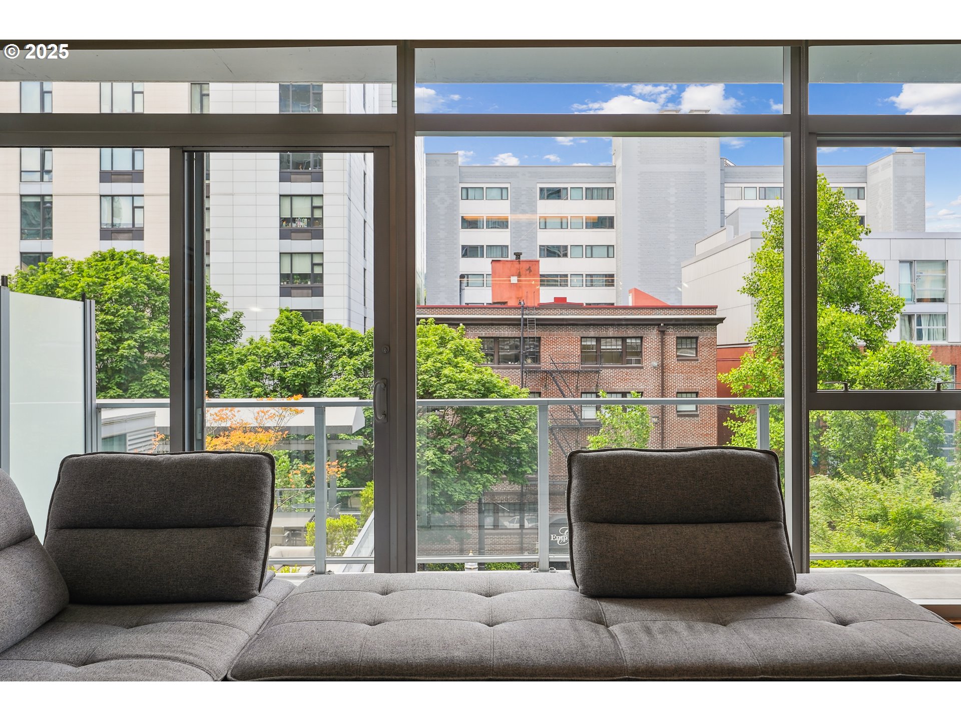 1221 Southwest 10th Avenue, Unit 410 Portland, OR 97205 - Photo 7 of 26 a living room filled with furniture and a large window