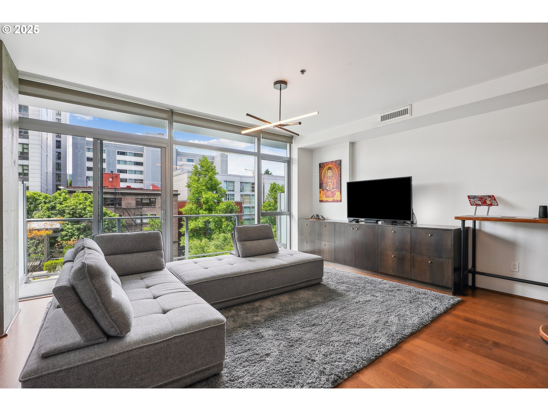 1221 Southwest 10th Avenue, Unit 410 Portland, OR 97205 - Photo 10 of 26 a living room with furniture and a flat screen tv