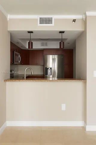 a kitchen with a sink and a refrigerator