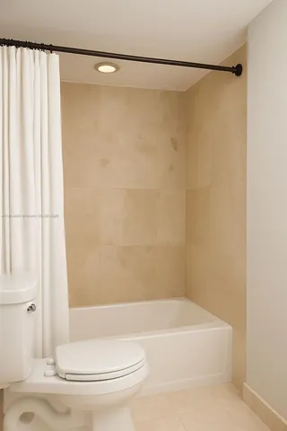 a bathroom with a shower and a toilet