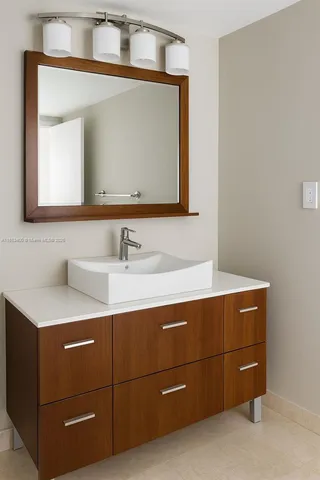 a bathroom with a sink vanity and mirror