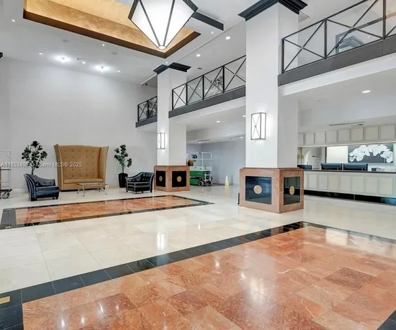 a lobby with furniture and a table