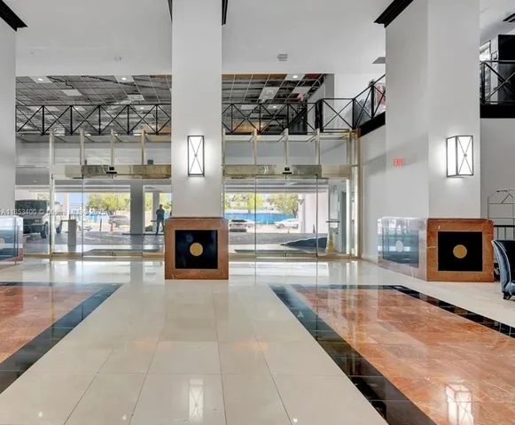 a living room with furniture a fireplace and kitchen view