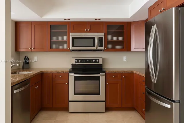 a kitchen with stainless steel appliances granite countertop a refrigerator stove and microwave