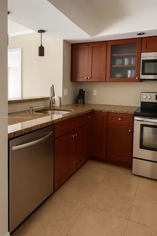 a kitchen with a sink stove top oven and microwave