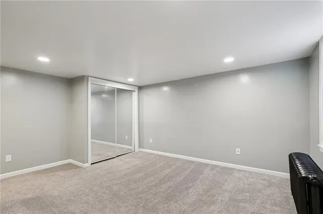 an empty room with windows and closet
