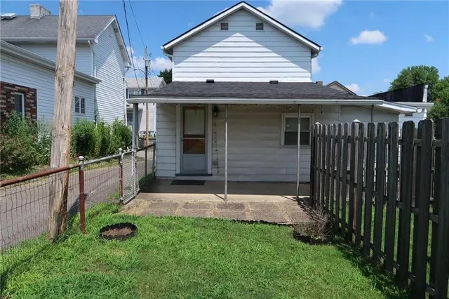 a view of a house with brick walls and a yard with table