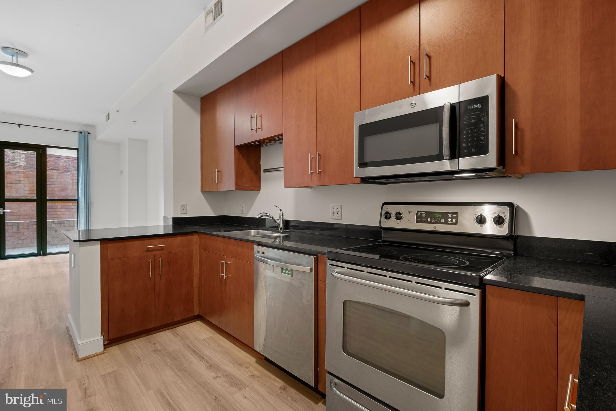 910 M Street Northwest, Unit 126 Washington, DC 20001 - Photo 11 of 54 a kitchen with stainless steel appliances a stove microwave and sink