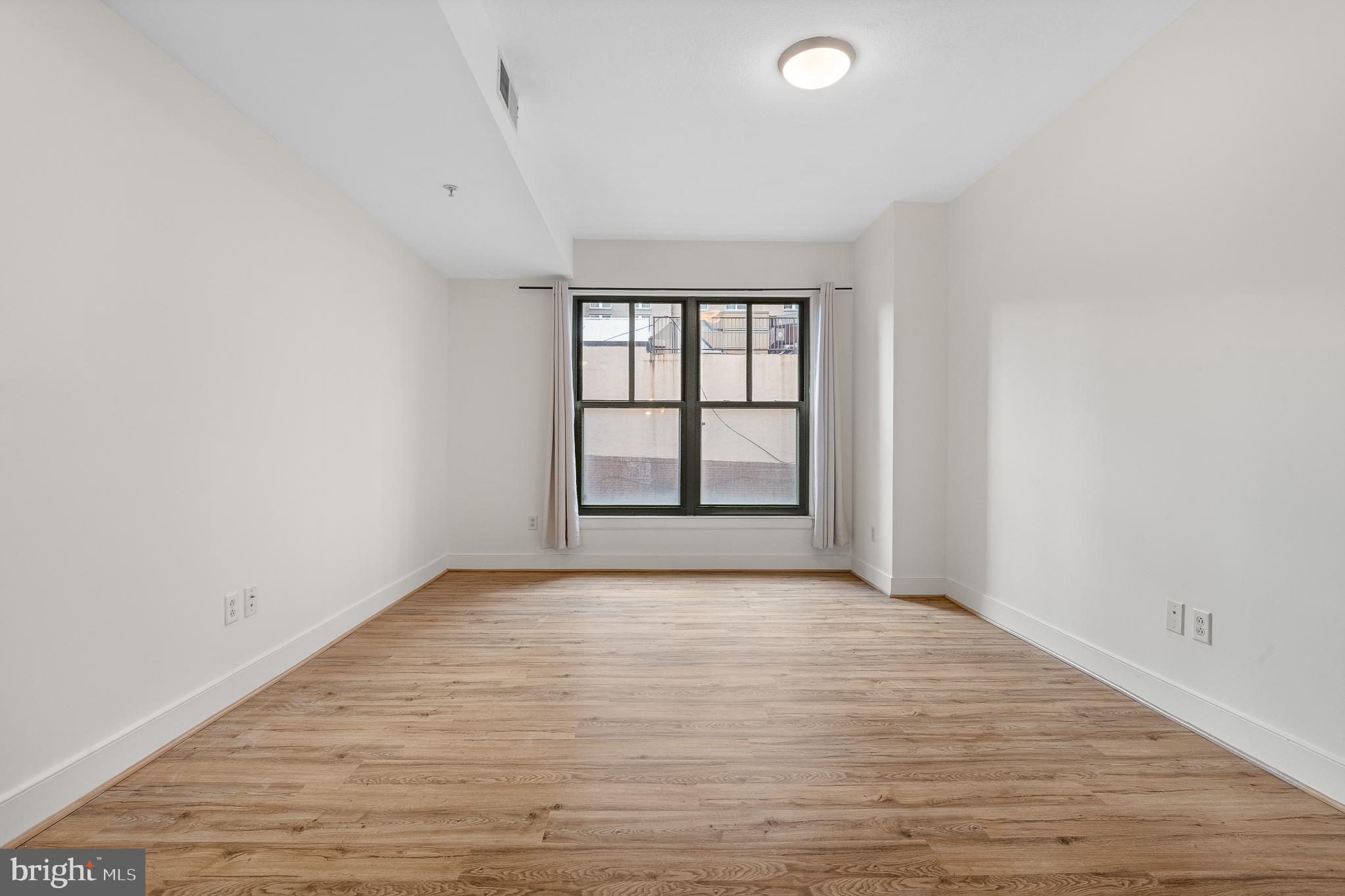 910 M Street Northwest, Unit 126 Washington, DC 20001 - Photo 20 of 54 wooden floor in an empty room with a window