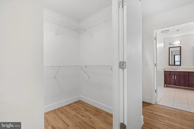 a bathroom with a bathtub a double vanity sink and mirror
