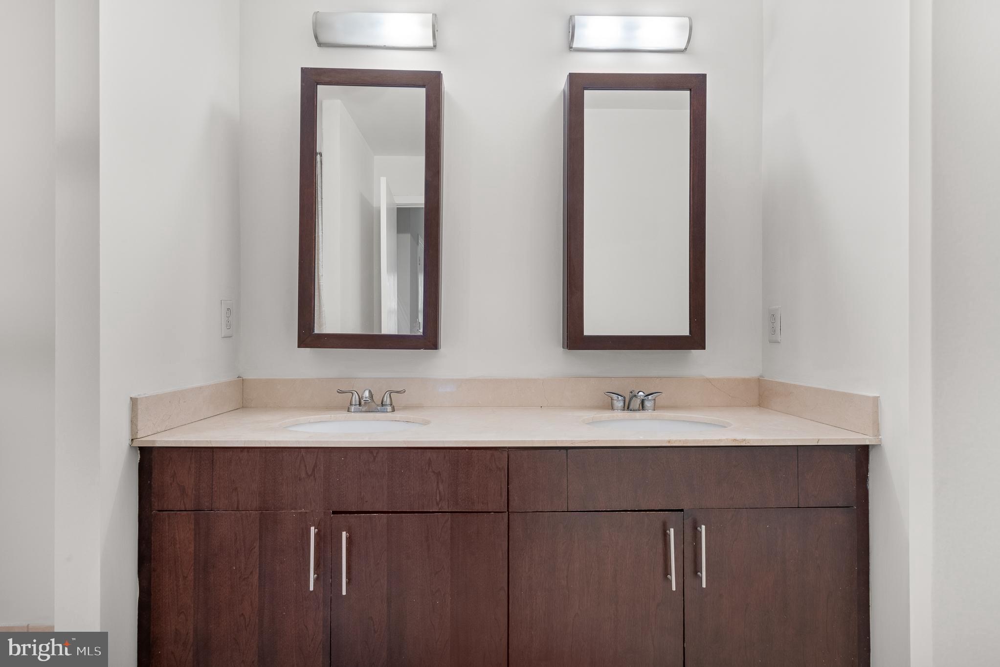 910 M Street Northwest, Unit 126 Washington, DC 20001 - Photo 30 of 54 a bathroom with a double vanity sink and a mirror