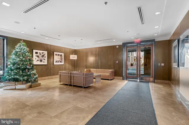 a living room with furniture and potted plants
