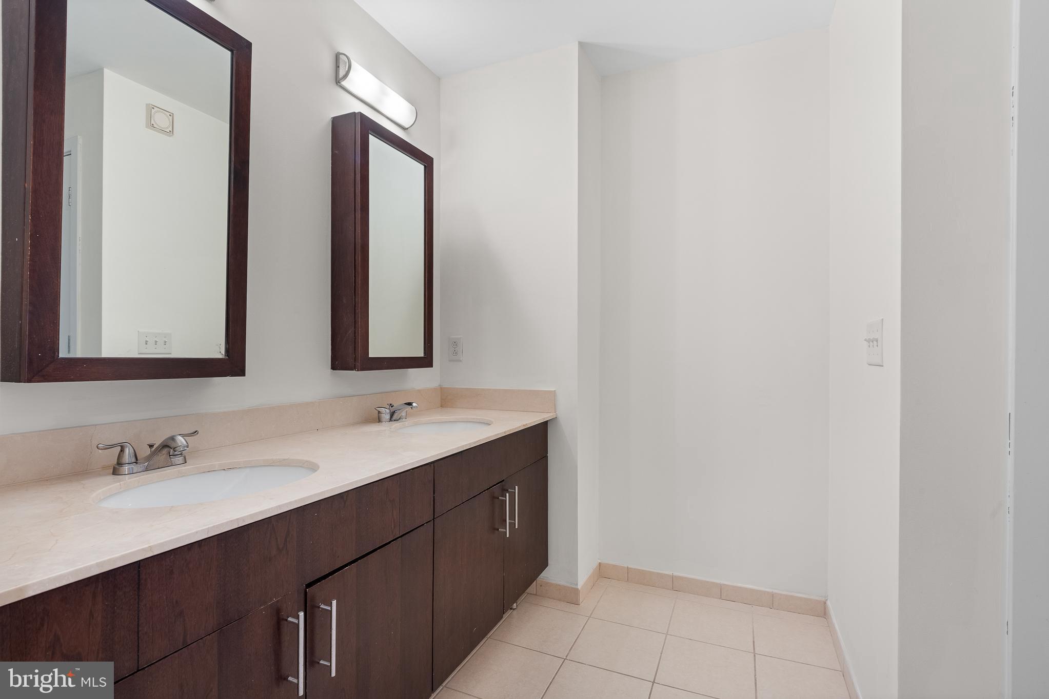 910 M Street Northwest, Unit 126 Washington, DC 20001 - Photo 35 of 54 a bathroom with a double vanity sink and a mirror