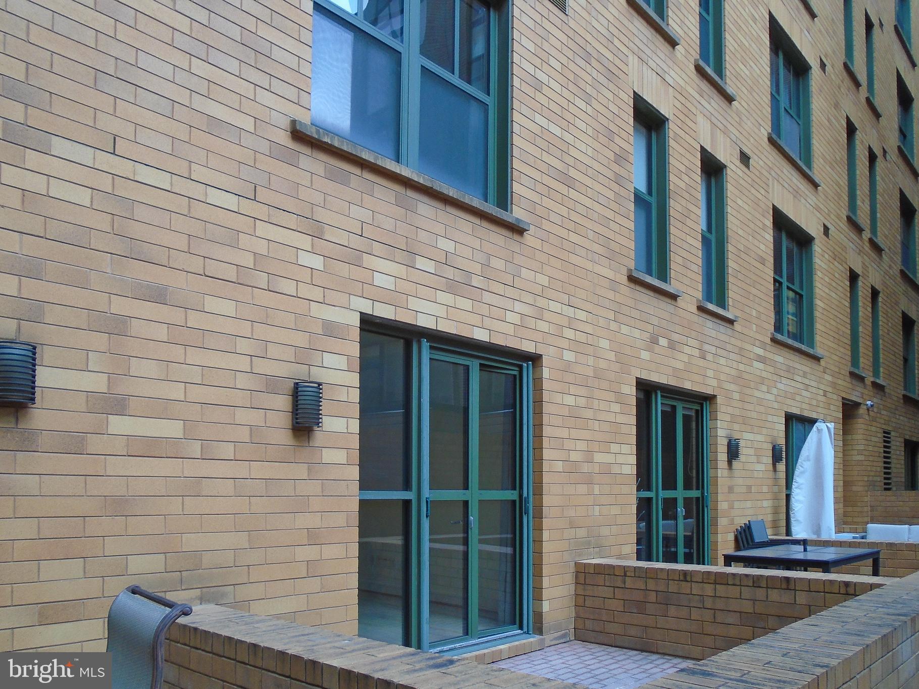 910 M Street Northwest, Unit 126 Washington, DC 20001 - Photo 37 of 54 a view of brick building with large windows