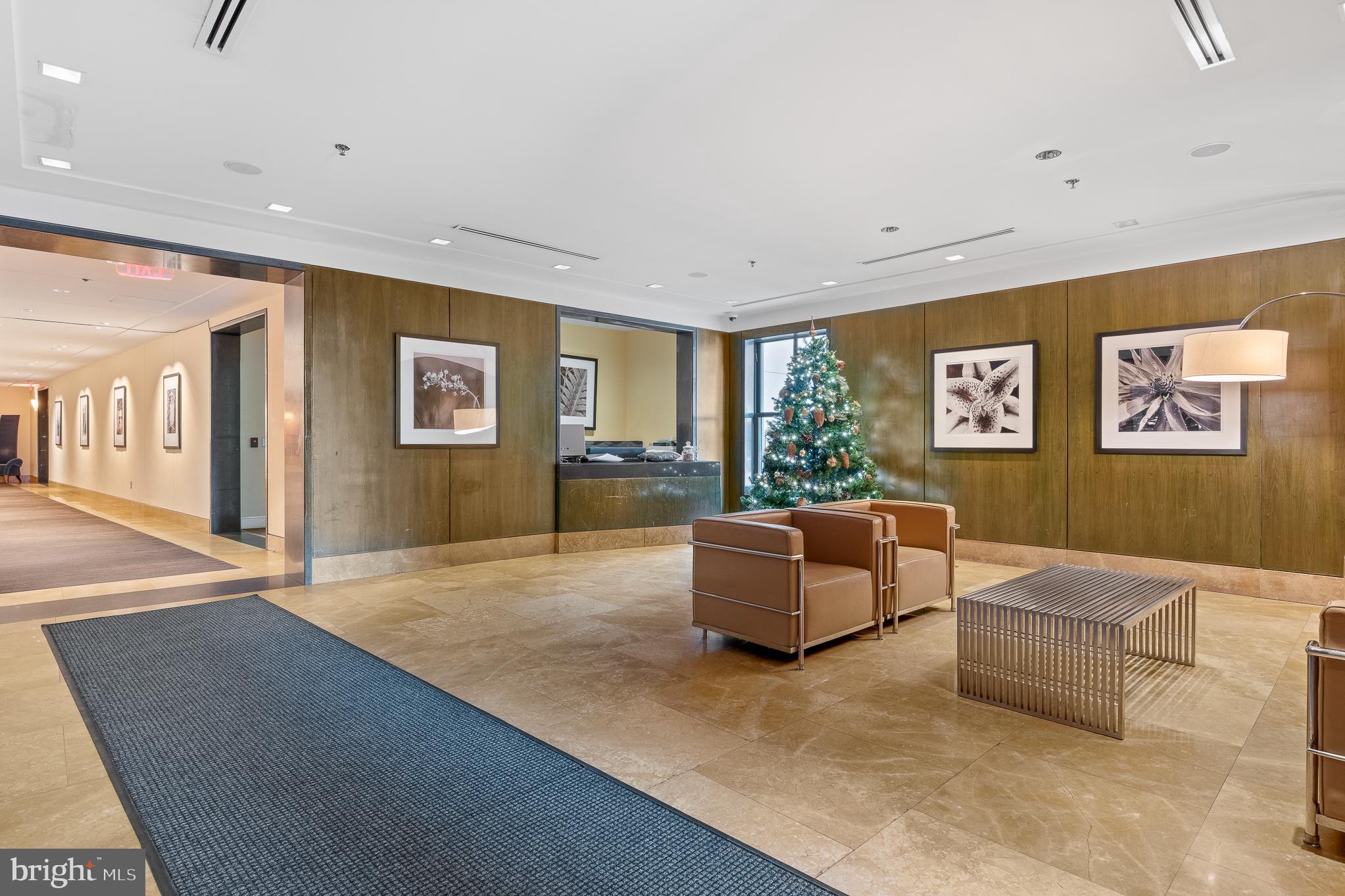 910 M Street Northwest, Unit 126 Washington, DC 20001 - Photo 4 of 54 a living room with couches and kitchen view with wooden floor