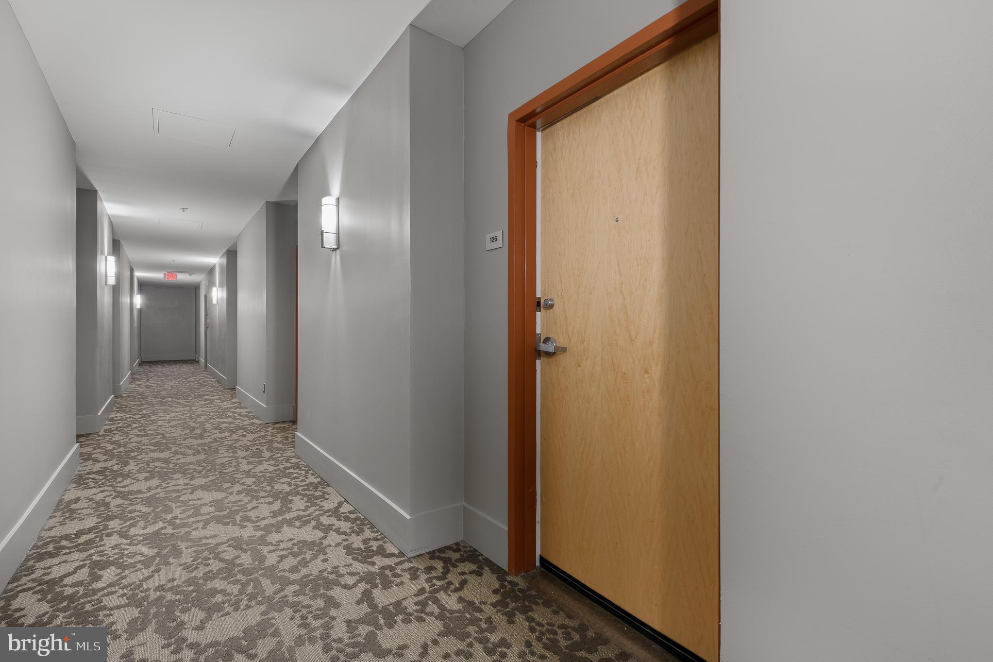 910 M Street Northwest, Unit 126 Washington, DC 20001 - Photo 7 of 54 a view of a hallway with wooden floor and a bathroom