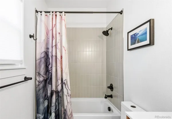 a bathroom with a shower a bath tub and a shower
