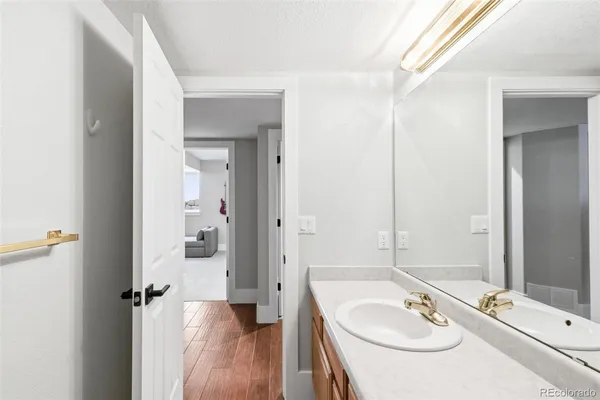 a bathroom with a double vanity sink and mirror with shower