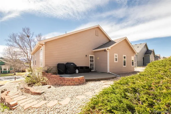 a view of a house with a yard covered in snow