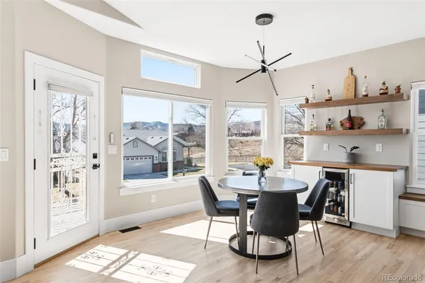 a dining room with furniture a chandelier and wooden floor