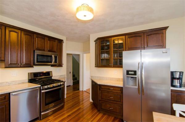 a kitchen with granite countertop stainless steel appliances and wooden cabinets