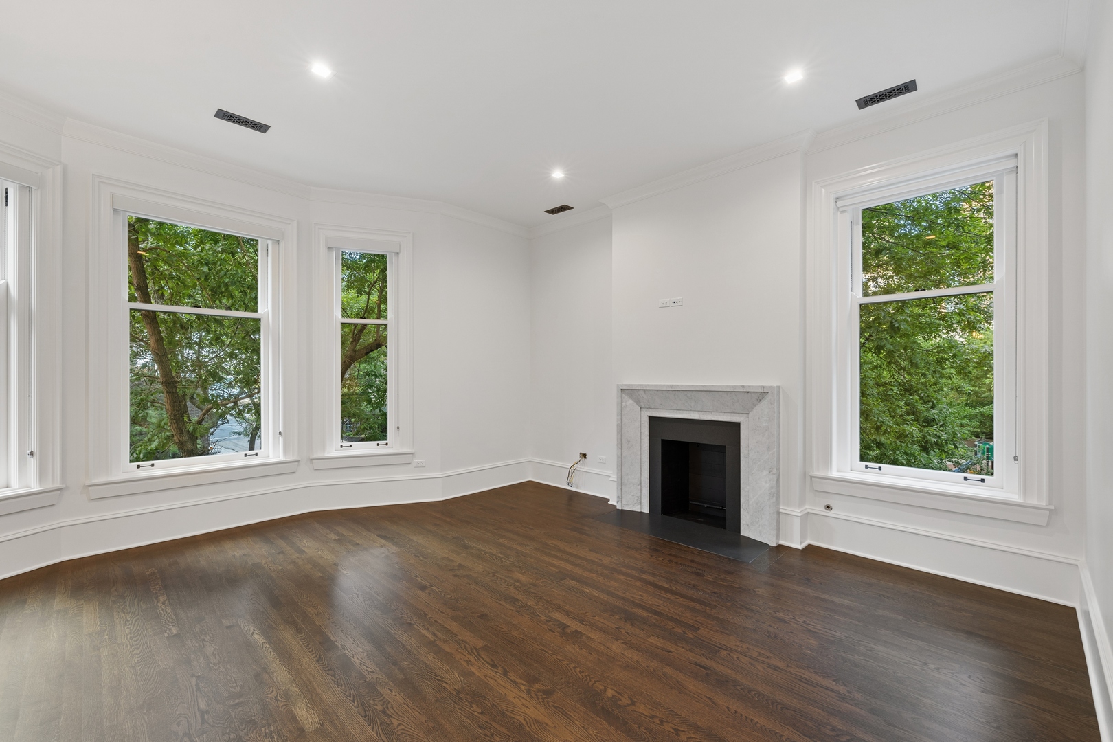 1300 North Ritchie Court, Unit 2 Chicago, IL 60610 - Photo 11 of 25 an empty room with wooden floor fireplace and windows