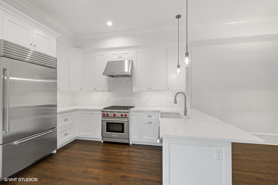 1300 North Ritchie Court, Unit 2 Chicago, IL 60610 - Photo 14 of 25 a kitchen with stainless steel appliances a stove and a refrigerator