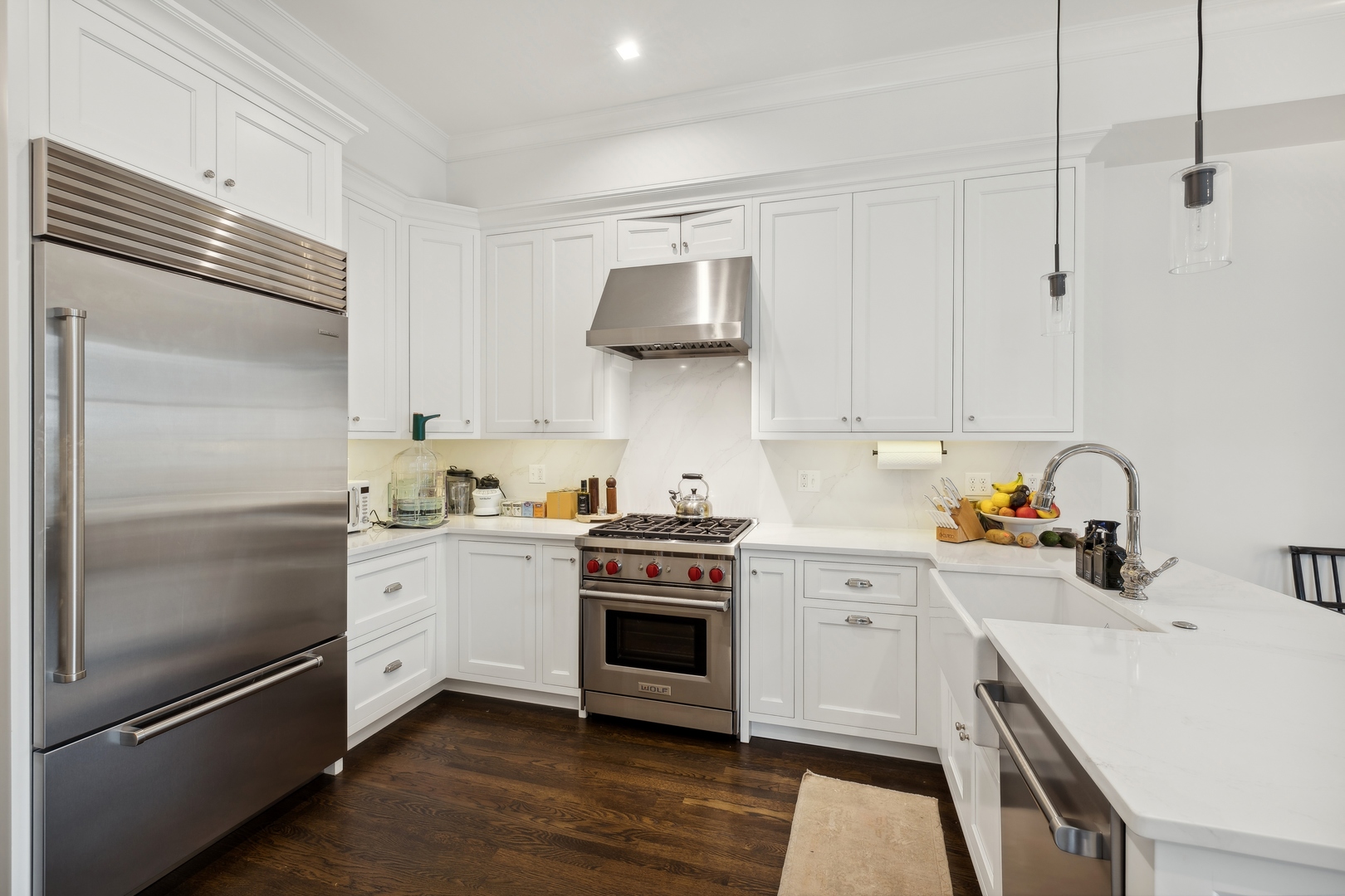 1300 North Ritchie Court, Unit 2 Chicago, IL 60610 - Photo 15 of 25 a kitchen with stainless steel appliances and white cabinets