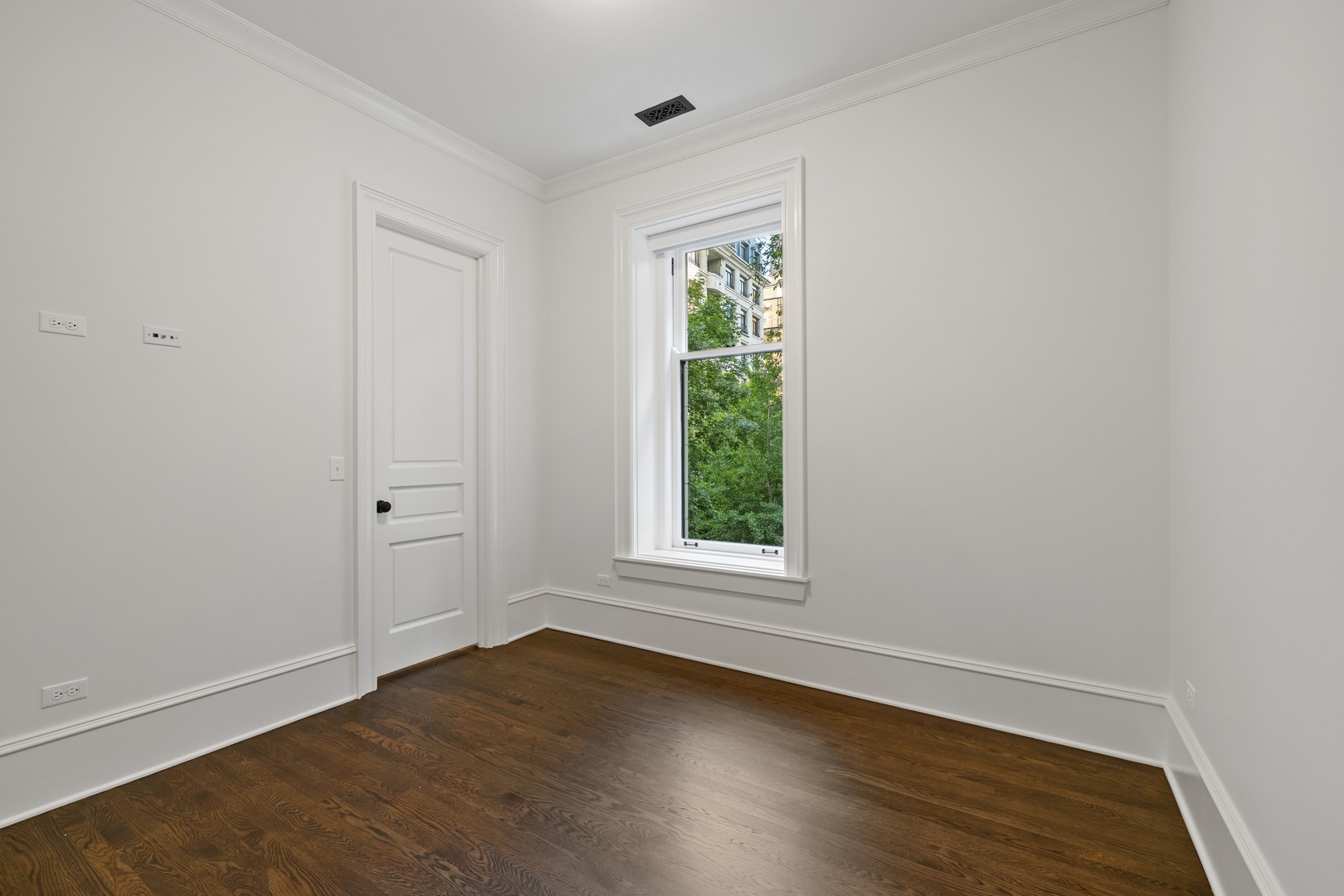 1300 North Ritchie Court, Unit 2 Chicago, IL 60610 - Photo 22 of 25 an empty room with wooden floor and windows