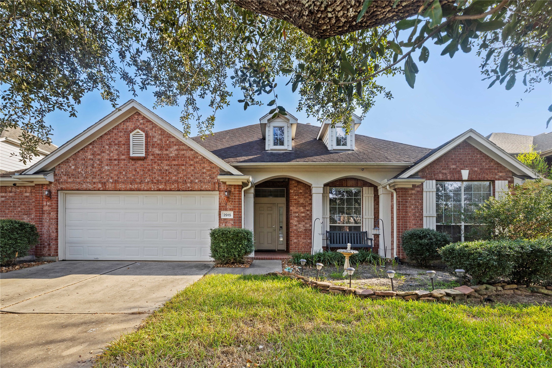 a front view of a house with a yard garage and outdoor seating