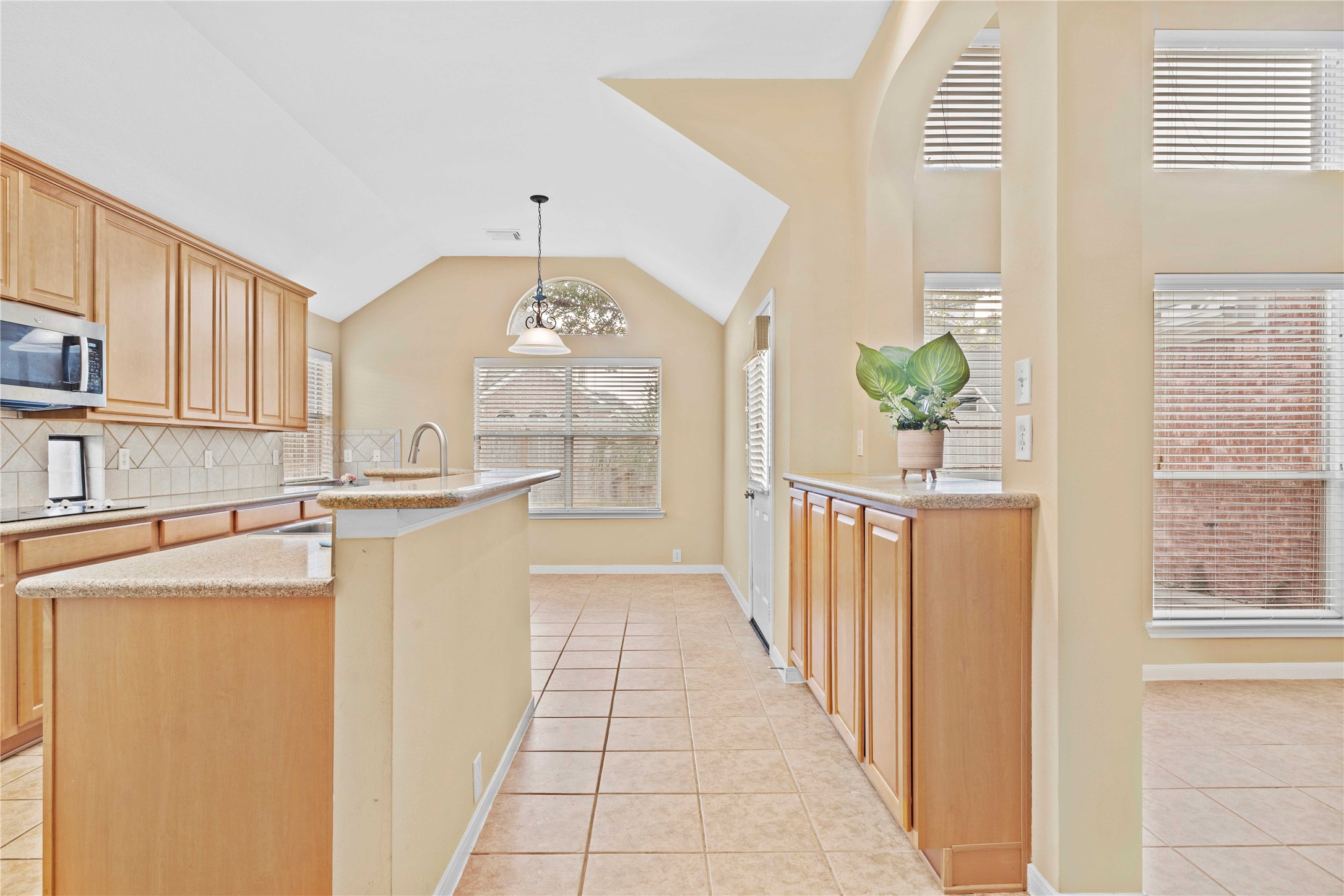 2915 Sandleigh Drive Spring, TX 77388 - Photo 12 of 30 a kitchen with stainless steel appliances a white refrigerator a stove and a window