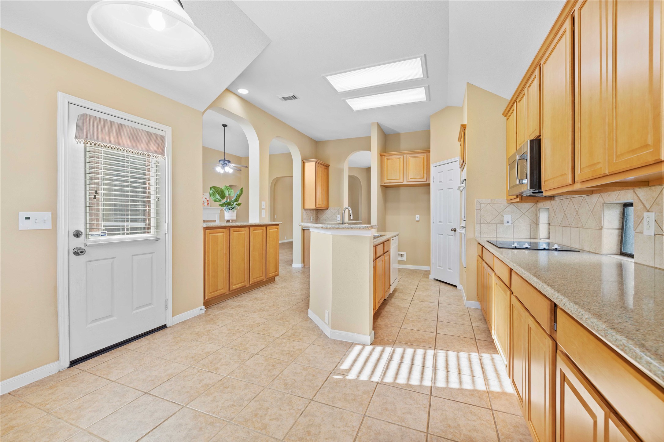 2915 Sandleigh Drive Spring, TX 77388 - Photo 13 of 30 a kitchen with granite countertop a sink and a refrigerator