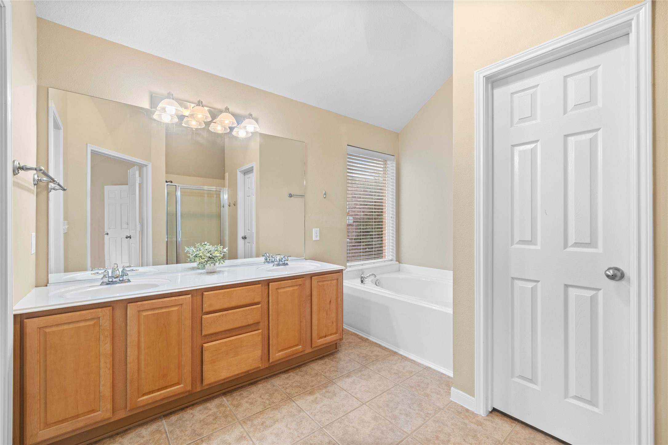 2915 Sandleigh Drive Spring, TX 77388 - Photo 20 of 30 a spacious bathroom with a double vanity sink a mirror and a bathtub