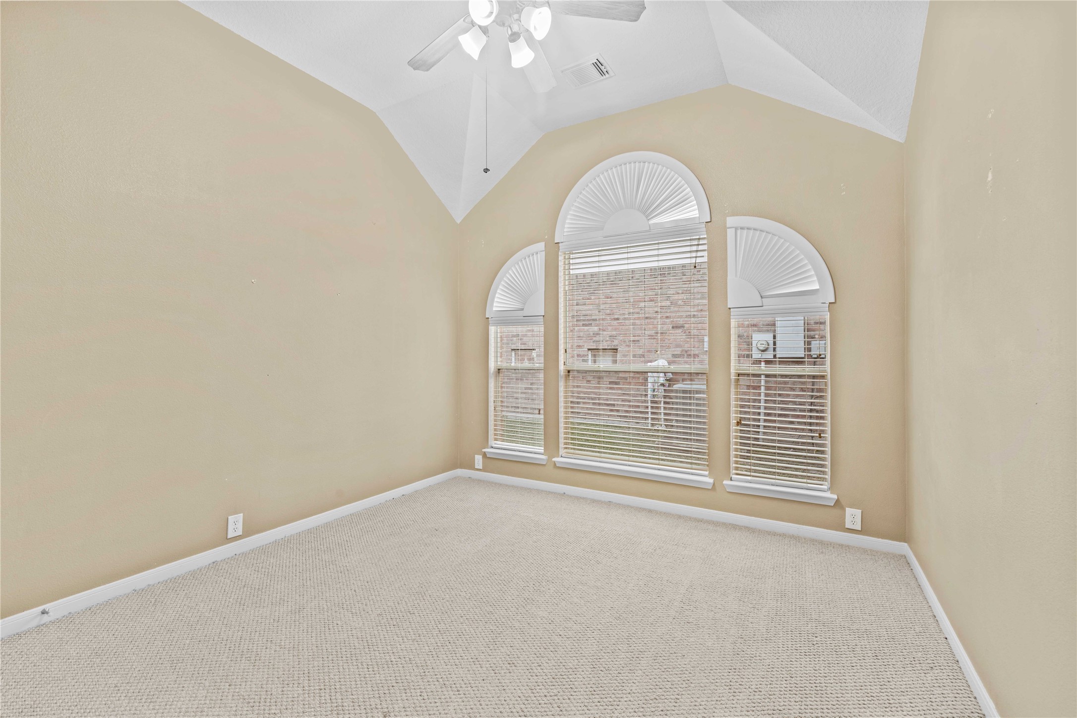 2915 Sandleigh Drive Spring, TX 77388 - Photo 23 of 30 an empty room with wooden floor fan and windows