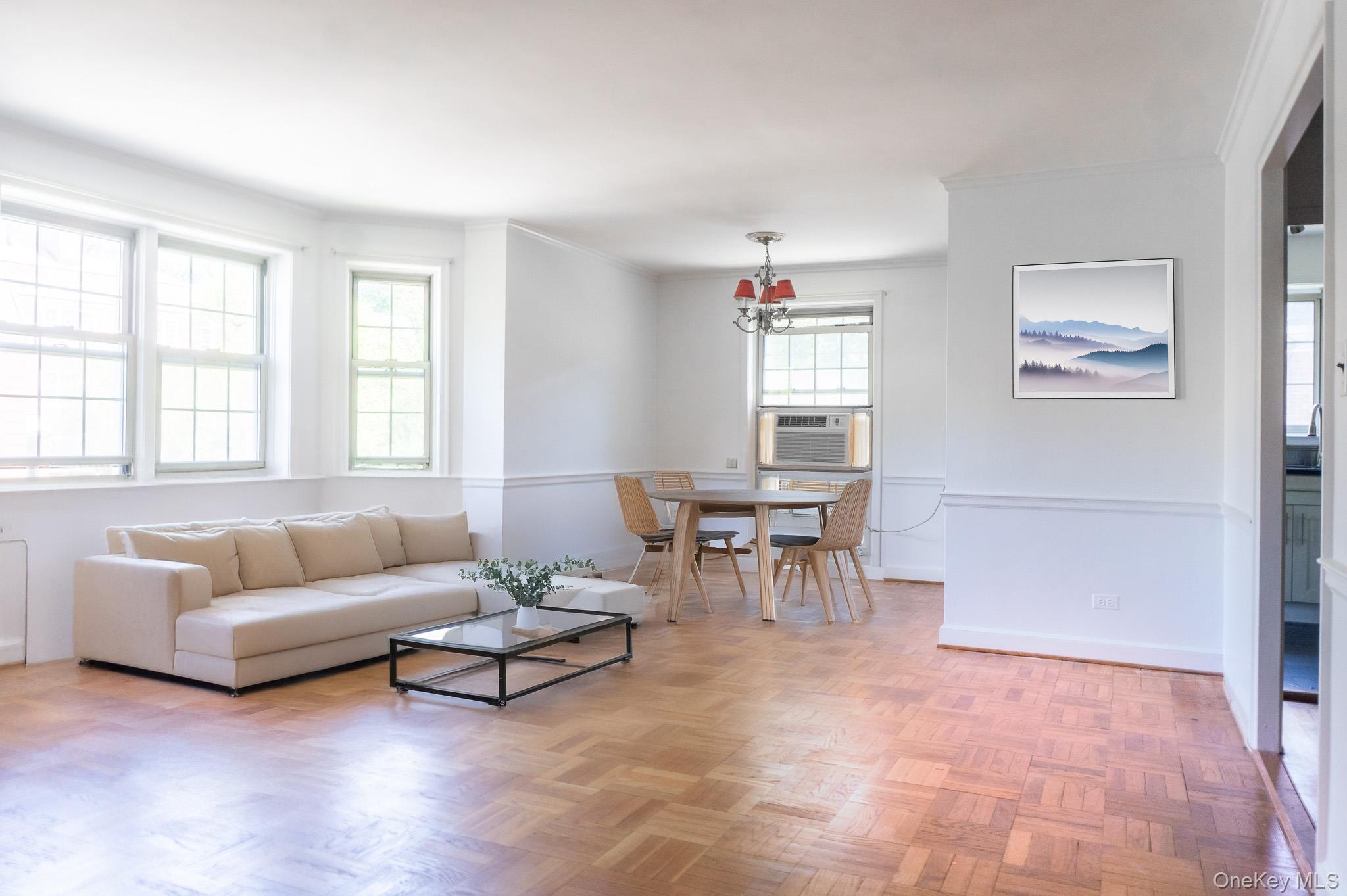 7 Chateaux Circle, Unit 7E Scarsdale, NY 10583 - Photo 5 of 28 virtual staging Living room with ornamental molding, a chandelier, and cooling unit