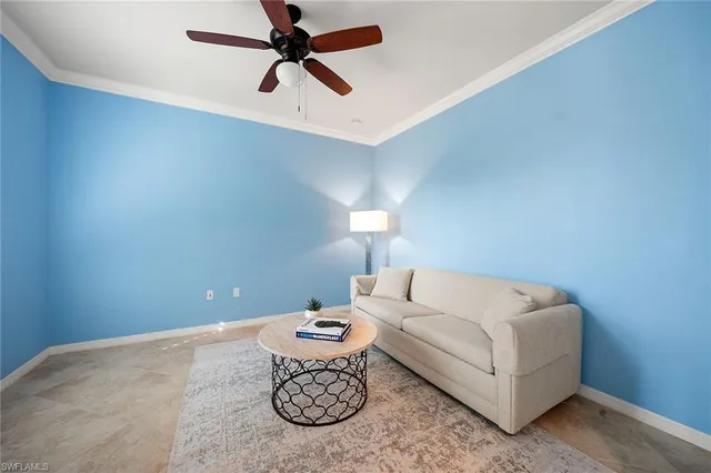 a living room with furniture and a ceiling fan
